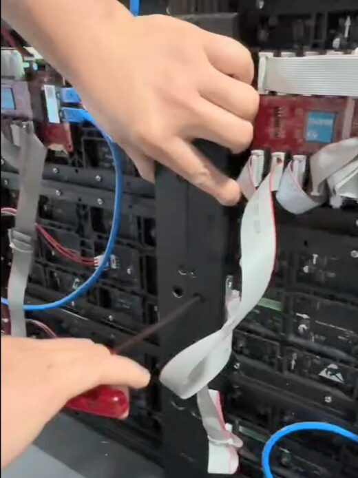 connected cables and electronic components visible during the installation process