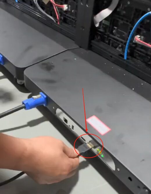 connecting input and output signal cables to a large LED video wall with complex wiring