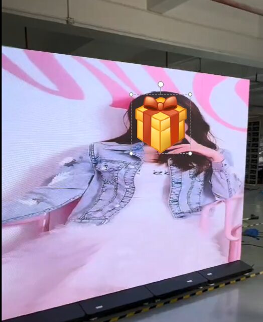 LED display screen showing an image with a gift box icon overlay